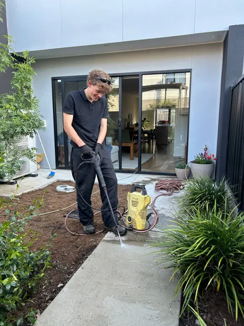 Julian pressure washing a path