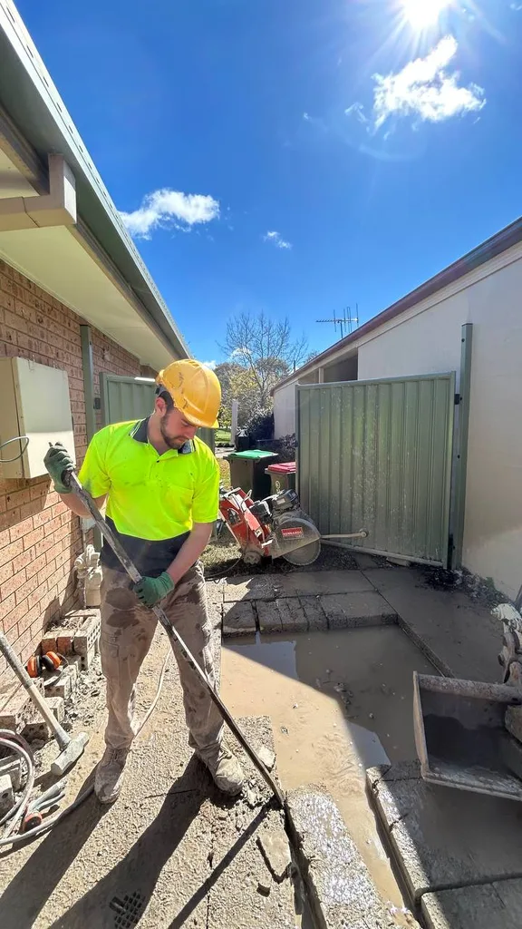 Team member working on concrete at a property