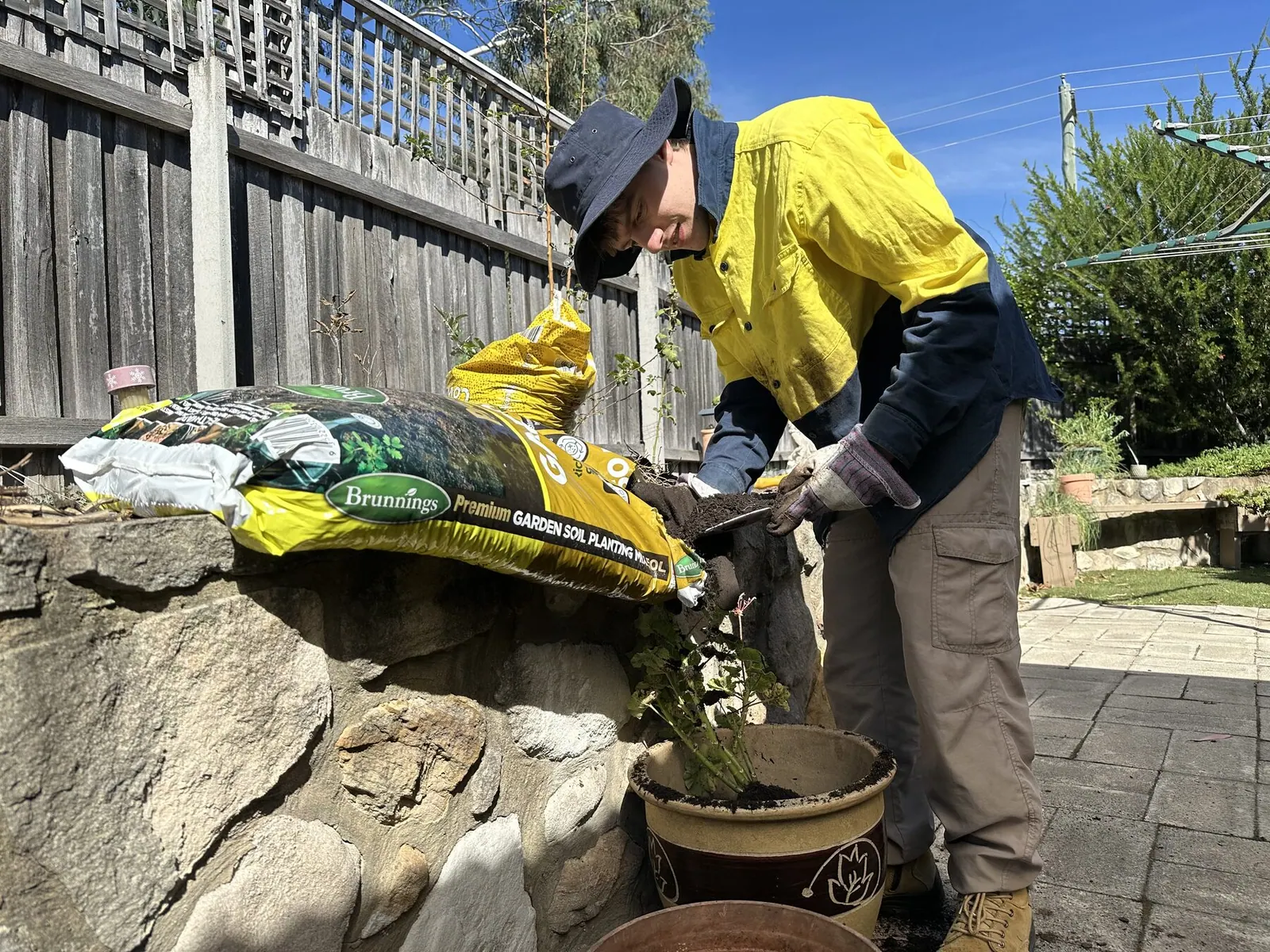 Team member planting in a garden bed